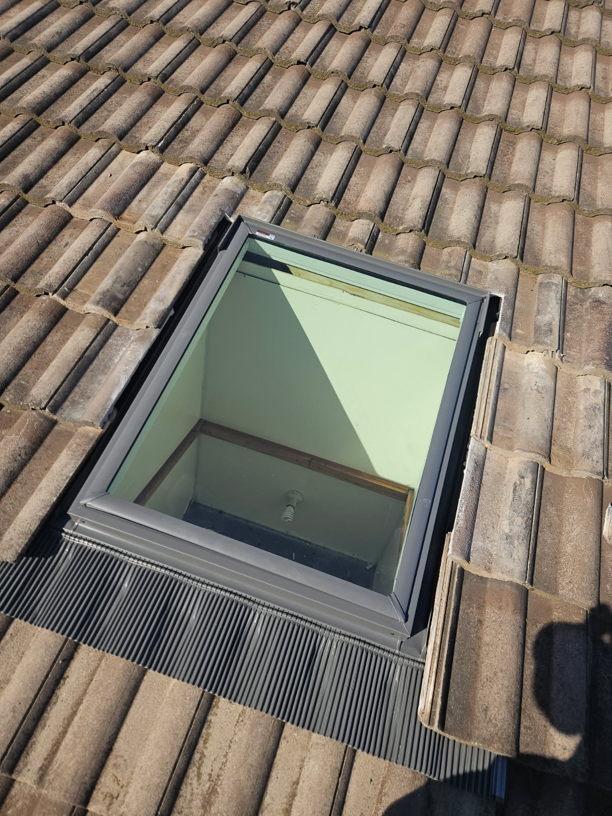 Velux skylight cut into a tile roof — Heasly & Son skylights Melbourne